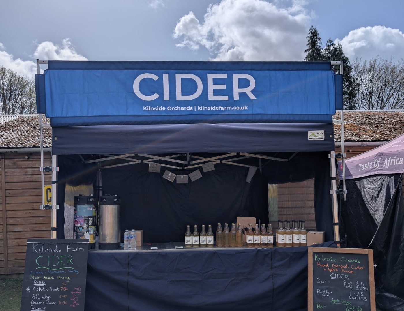 The Kilnside Orchards stall under its blue CIDER banner, with chalkboard menus either side